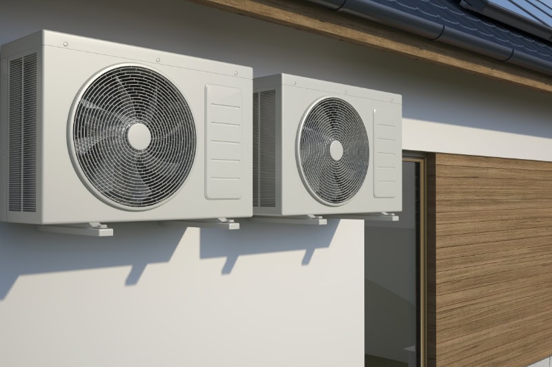 air conditioners attached to a building's wall.